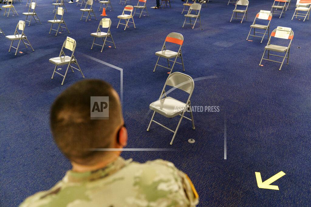 David Goldman FILE - In this June 10, 2021, file photo, Rhode Island Army National Guard Sgt. Juan Gomez looks over the post inoculation waiting area at a coronavirus mass-vaccination site at the former Citizens Bank headquarters in Cranston, R.I. As cases fall and states reopen, the potential final stage in the U.S. campaign to vanquish COVID-19 is turning into a slog, with a worrisome variant gaining a bigger foothold and lotteries and other inducements failing to persuade some Americans to get vaccinated. (AP Photo/David Goldman)