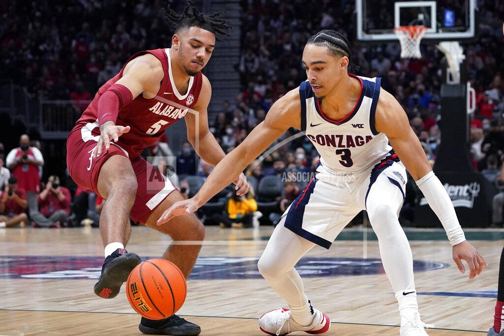 Elaine Thompson Alabama's Jaden Shackelford, left, tries to get a foot on the ball as Gonzaga's Andrew Nembhard reaches for the ball during the first half of an NCAA college basketball game Saturday, Dec. 4, 2021, in Seattle. (AP Photo/Elaine Thompson)