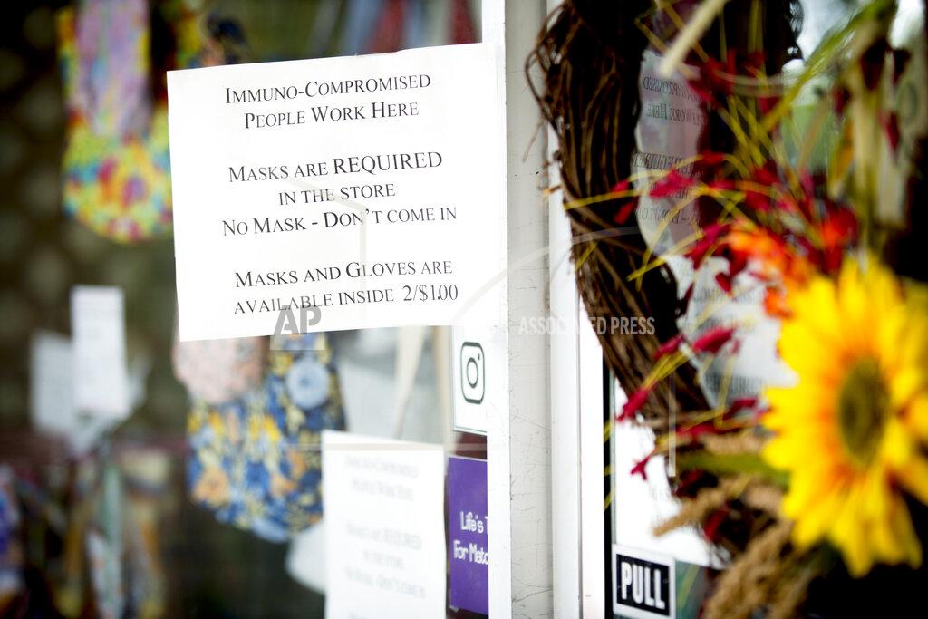 Isaac Hale A face mask notice is displayed outside of a business in downtown Provo, Utah, on Thursday, Aug. 27, 2020. (Isaac Hale/The Daily Herald via AP)