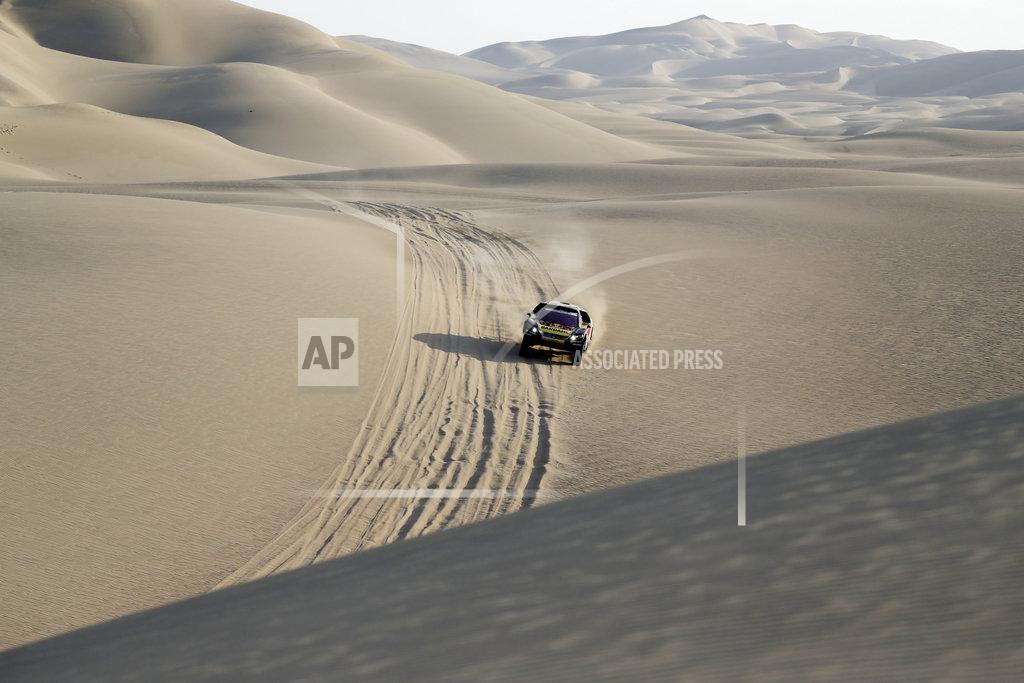 Ricardo Mazalan Driver Sebastien Loeb, of France, and co-driver Daniel Elena, of Monaco, race their Peugeot during the second stage of the Dakar Rally between Pisco and San Juan de Marcona, Peru, Tuesday, Jan. 8, 2019. (AP Photo/Ricardo Mazalan)