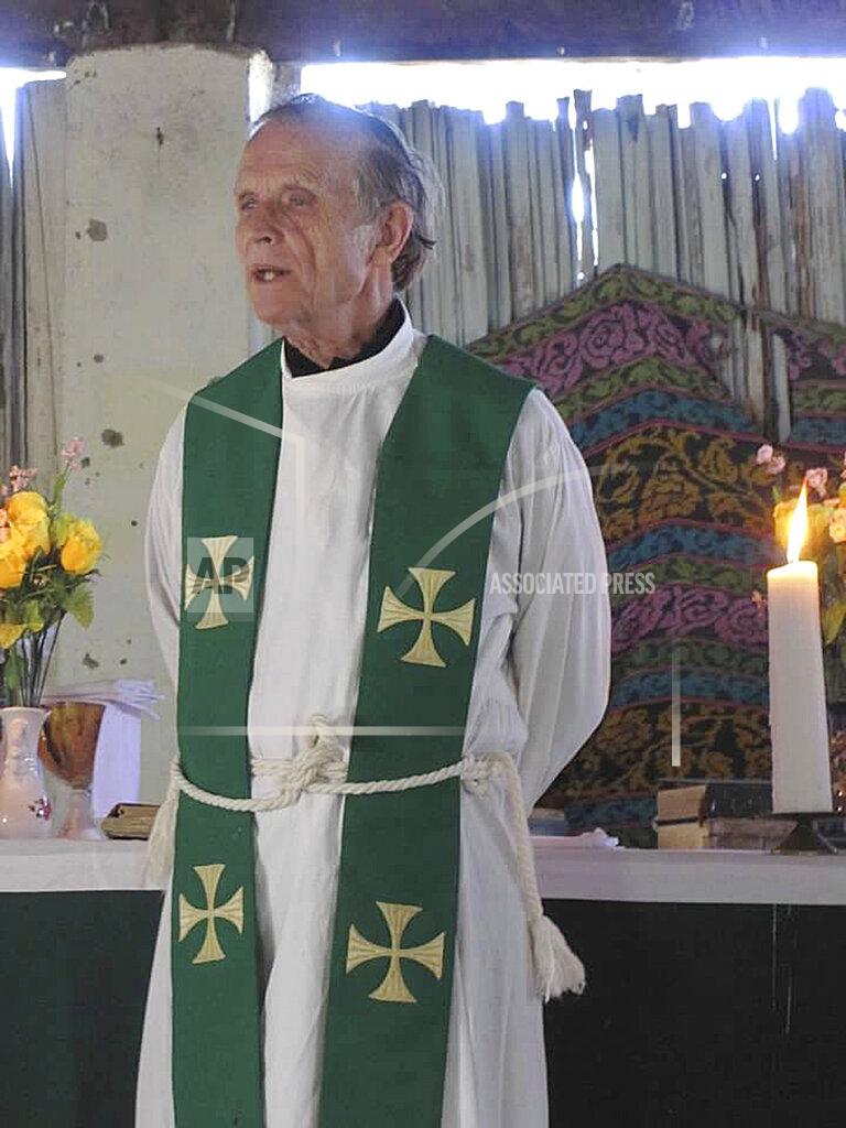 Uncredited This 2013 photo provided to The Associated Press shows now-defrocked Catholic priest Richard Daschbach leading a service at a church in Kutet, East Timor. The church defrocked Daschbach in 2018, saying he had confessed to sexually abusing children. But he has widespread support, including backing from a former president of East Timor, who is also an independence hero. (AP Photo)