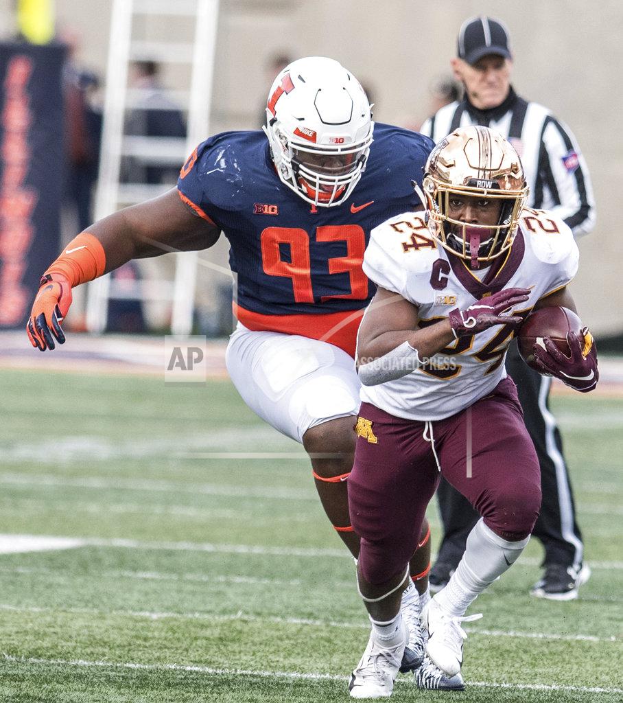 Holly Hart Minnesota's Mohamed Ibrahim (24) out runs the grasp of Illinois' Calvin Avery (93) in the first half of a NCAA college football game Saturday, Nov. 3, 2018, in Champaign, Ill. (AP Photo/Holly Hart)