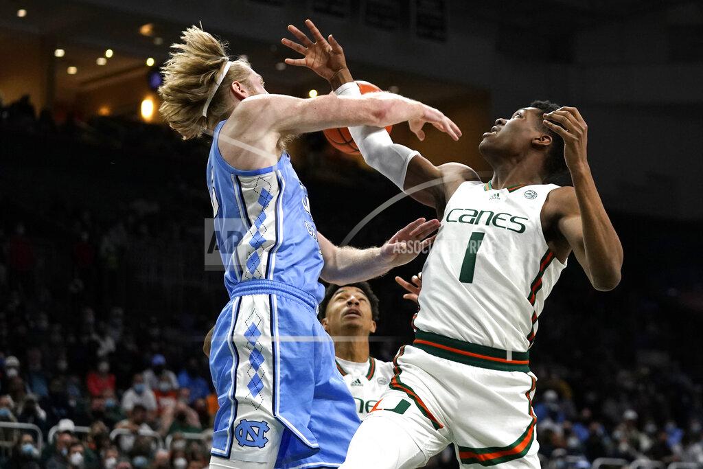 Lynne Sladky North Carolina forward Brady Manek, left, and Miami forward Anthony Walker (1) go for a rebound during the first half of an NCAA college basketball game, Tuesday, Jan. 18, 2022, in Coral Gables, Fla. (AP Photo/Lynne Sladky)