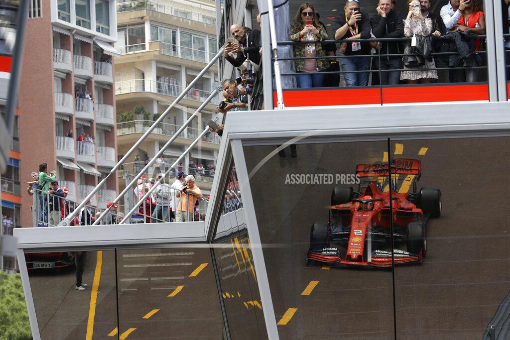 Luca Bruno Ferrari driver Sebastian Vettel of Germany is reflected on the glass of the paddock during the second practice session at the Monaco racetrack, in Monaco, Thursday, May 23, 2019. The Formula one race will be held on Sunday. (AP Photo/Luca Bruno)