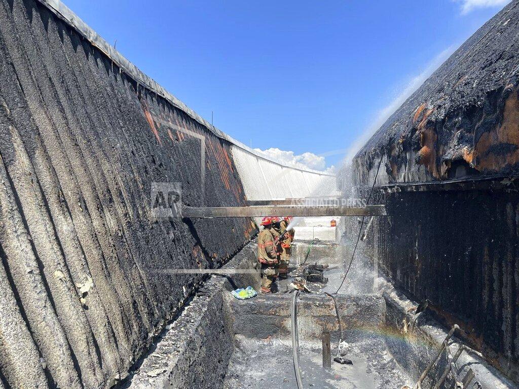 Uncredited This photo provided by NOLA Ready shows firefighters putting out a fire on the roof of New Orleans' Superdome on Tuesday, Sept. 21, 2021 in New Orleans. The New Orleans Fire Department says it responded to a fire about 1 p.m. Tuesday on the roof. A short time later it appeared under control. (NOLA Ready via AP)