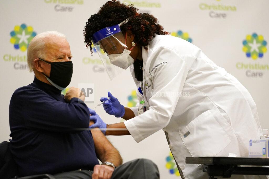 Carolyn Kaster President-elect Joe Biden receives his first dose of the coronavirus vaccine at ChristianaCare Christiana Hospital in Newark, Del., Monday, Dec. 21, 2020, from nurse practitioner Tabe Mase. (AP Photo/Carolyn Kaster)