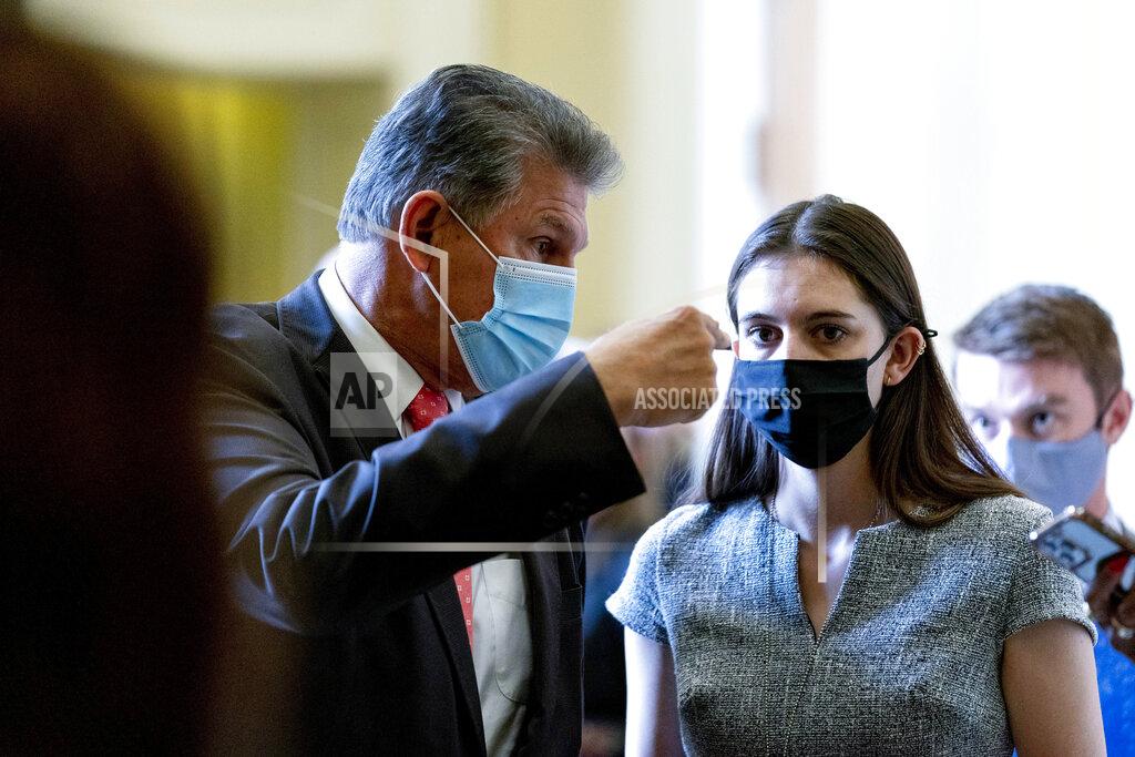 Andrew Harnik Sen. Joe Manchin, D-W.Va., speaks to an aide as he walks out of a Democratic policy luncheon as work continues on the Democrats' Build Back Better Act, massive legislation that is a cornerstone of President Joe Biden's domestic agenda, at the Capitol, in Washington, Tuesday, Sept. 14, 2021. (AP Photo/Andrew Harnik)