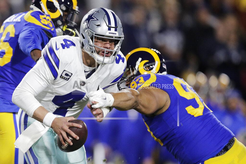 Jae C. Hong Dallas Cowboys quarterback Dak Prescott breaks away from Los Angeles Rams nose tackle Ndamukong Suh during the first half in an NFL divisional football playoff game Saturday, Jan. 12, 2019, in Los Angeles. (AP Photo/Jae C. Hong)