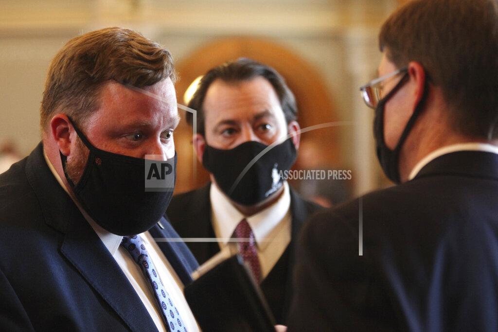 John Hanna FILE - In this Tuesday, March 30, 2021 file photo, Kansas House Speaker Pro Tem Blaine Finch, left, R-Ottawa, speaks with GOP colleagues during a House debate at the Statehouse in Topeka, Kan. Finch said he believes changes in Kansas’ emergency management law will encourage future governors to “use that power sparingly” and collaborate with lawmakers. “Our system is set up not to give one person of any party too much power over the lives of Kansans," he said. “We’re supposed to have checks and balances.” (AP Photo/John Hanna)