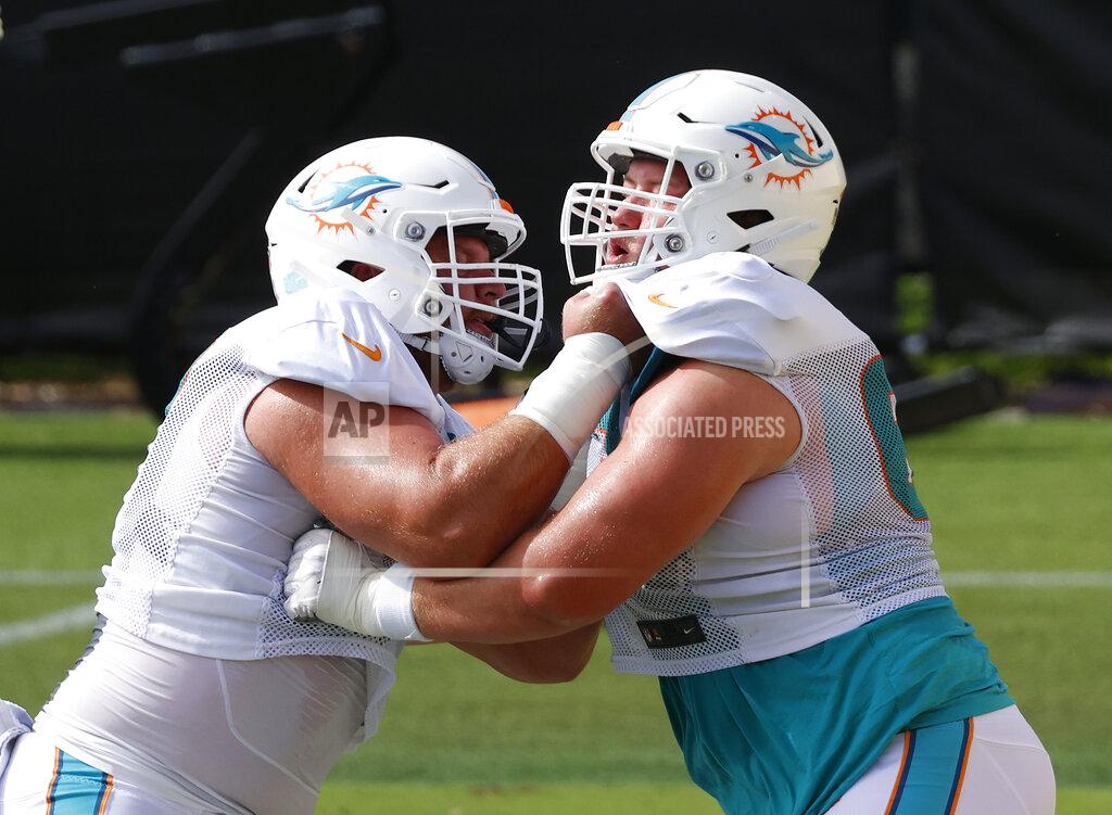 Joel Auerbach Miami Dolphins center Ted Karras (67), left, and guard Michael Deiter (63) run a drill during an NFL football training camp practice in Davie, Fla., Monday, Aug. 17, 2020. (AP Photo/Joel Auerbach)