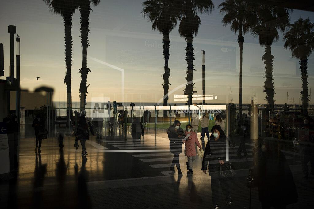 Felipe Dana People walk past the entrance of Hospital del Mar, in Barcelona, Spain, Tuesday, Jan. 19, 2021. The unrelenting increase in COVID-19 infections in Spain following the holiday season is again straining hospitals, threatening the mental health of doctors and nurses who have been at the forefront of the pandemic for nearly a year. (AP Photo/Felipe Dana)