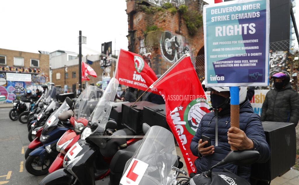 Alastair Grant Gig economy riders for app-based meal delivery platform Deliveroo demonstrate near the company headquarters in London, Wednesday, April 7, 2021. The strike coincides with the first day of unconditional trading for Deliveroo shares, which went public last week in a stock market offering.(AP Photo/Alastair Grant)