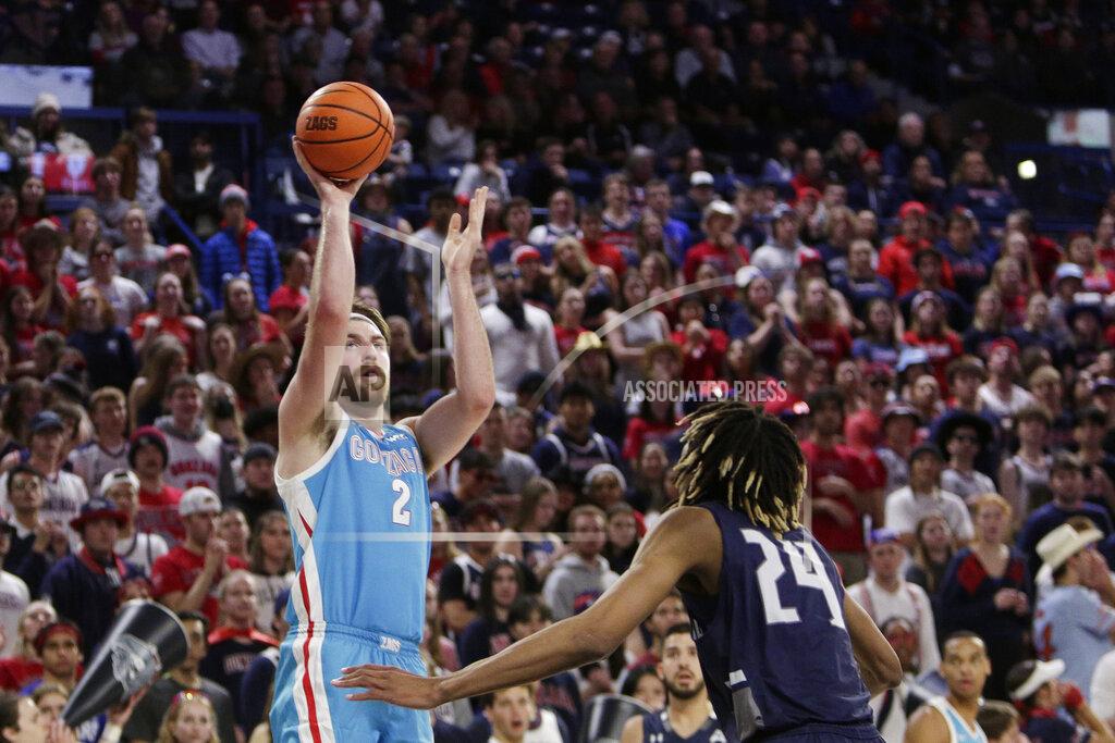 Young Kwak Gonzaga forward Drew Timme (2) shoots while defended by North Florida forward Jadyn Parker (24) during the first half of an NCAA college basketball game, Monday, Nov. 7, 2022, in Spokane, Wash. (AP Photo/Young Kwak)