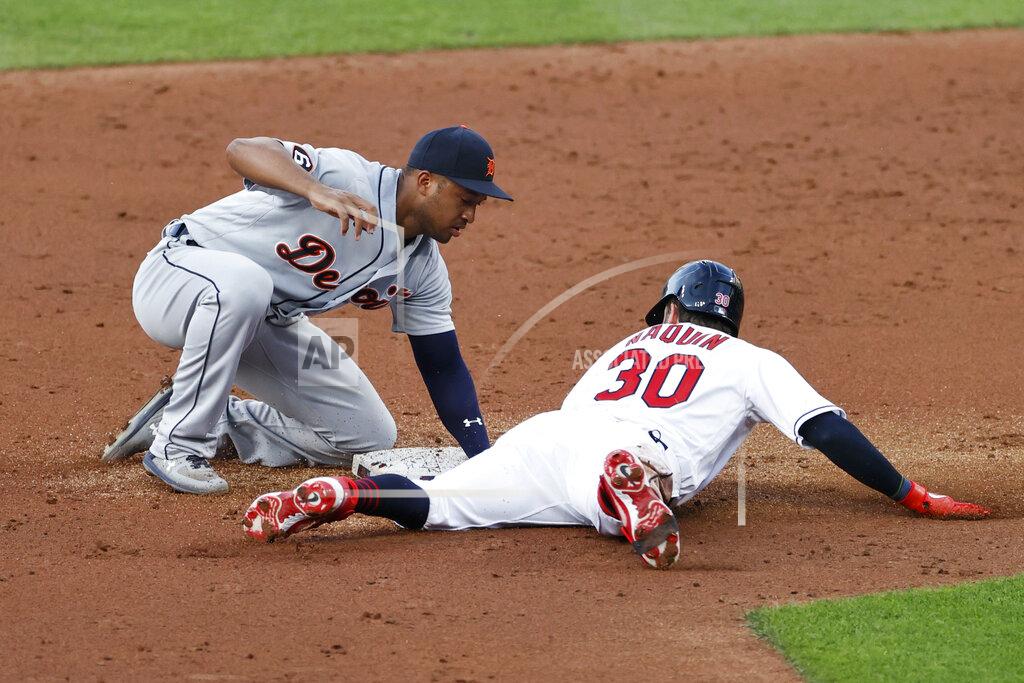 Ron Schwane Cleveland Indians' Tyler Naquin (30) slides safely into second base with a one-run double as Detroit Tigers' Jonathan Schoop, left, covers during the second inning of a baseball game, Friday, Aug. 21, 2020, in Cleveland. (AP Photo/Ron Schwane)