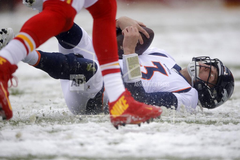 Charlie Riedel Denver Broncos quarterback Drew Lock (3) slides down in the snow after carrying the ball for a first down, during the first half of an NFL football game against the Kansas City Chiefs in Kansas City, Mo., Sunday, Dec. 15, 2019. (AP Photo/Charlie Riedel)