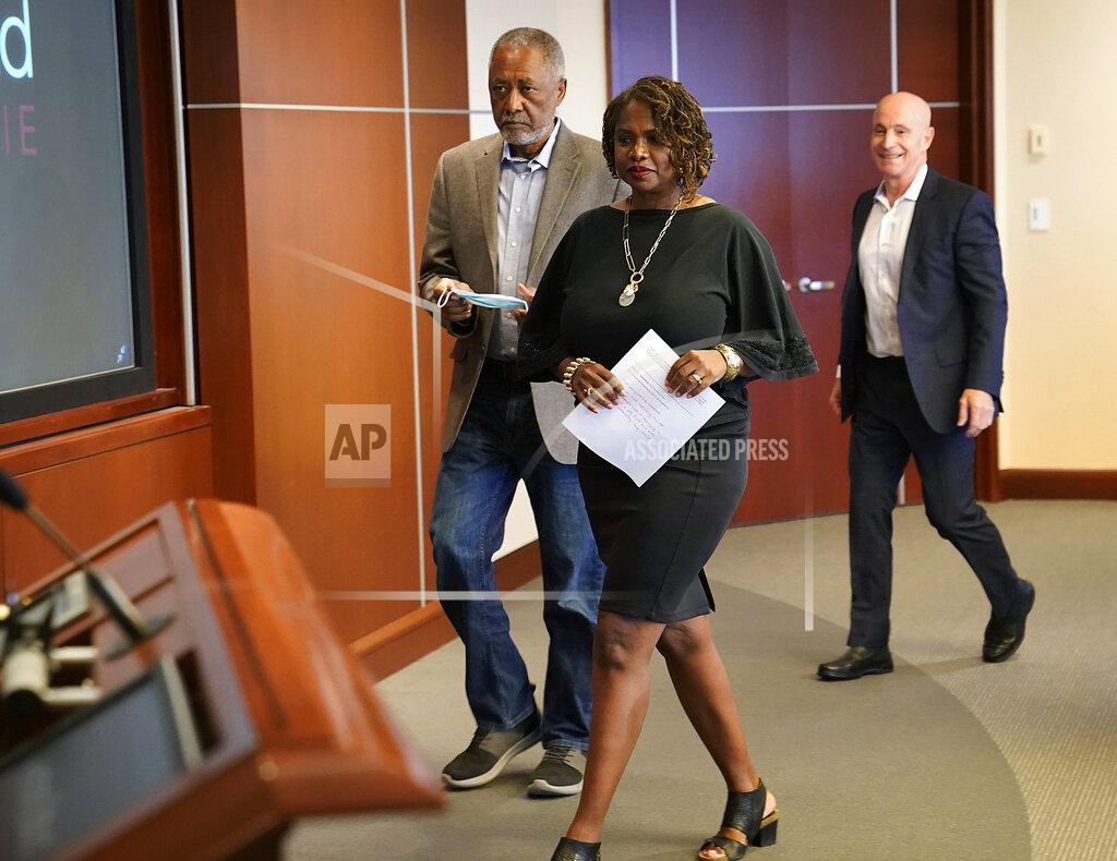 David Joles/Star Tribune Minneapolis residents Sondra Samuels, front, her husband, Don Samuels, left, and businessman Bruce Dachis, right, walk to the podium for the start of a press conference to discuss where the situation stands regarding language on the future of the Minneapolis policing ballot Wednesday, Sept. 15, 2021, in Minneapolis. A judge struck down ballot language last week that aimed to replace the Minneapolis Police Department with a new agency, which sent the City Council scrambling to approve new language that members hope will stand up. The injunction to keep the language off the ballot was sought by former City Council Member Samuels, his wife, and Dachis. (David Joles/Star Tribune via AP)
