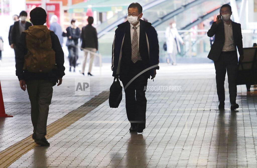 Koji Sasahara People wearing face masks to help curb the spread of the coronavirus walk underpass in Tokyo, Wednesday, Nov. 18, 2020. (AP Photo/Koji Sasahara)