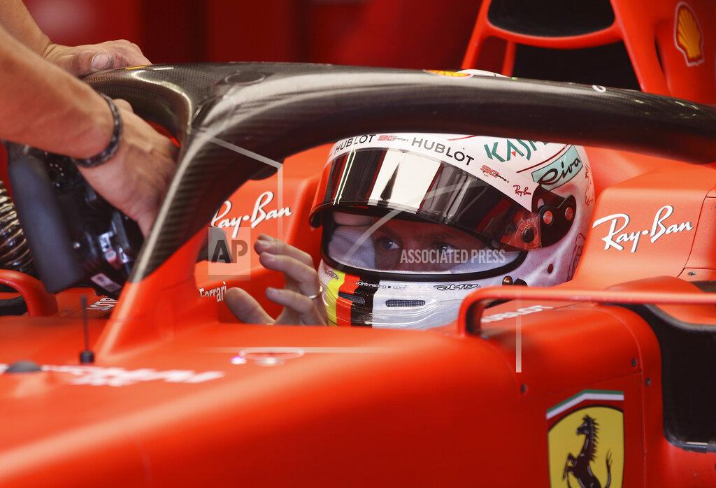 Ronald Zak Ferrari driver Sebastian Vettel of Germany is handed the car's steering wheel in the team box during the first free practice session for the Austrian Formula One Grand Prix at the Red Bull Ring racetrack in Spielberg, southern Austria, Friday, June 28, 2019. The race will be held on Sunday. (AP Photo/Ronald Zak)