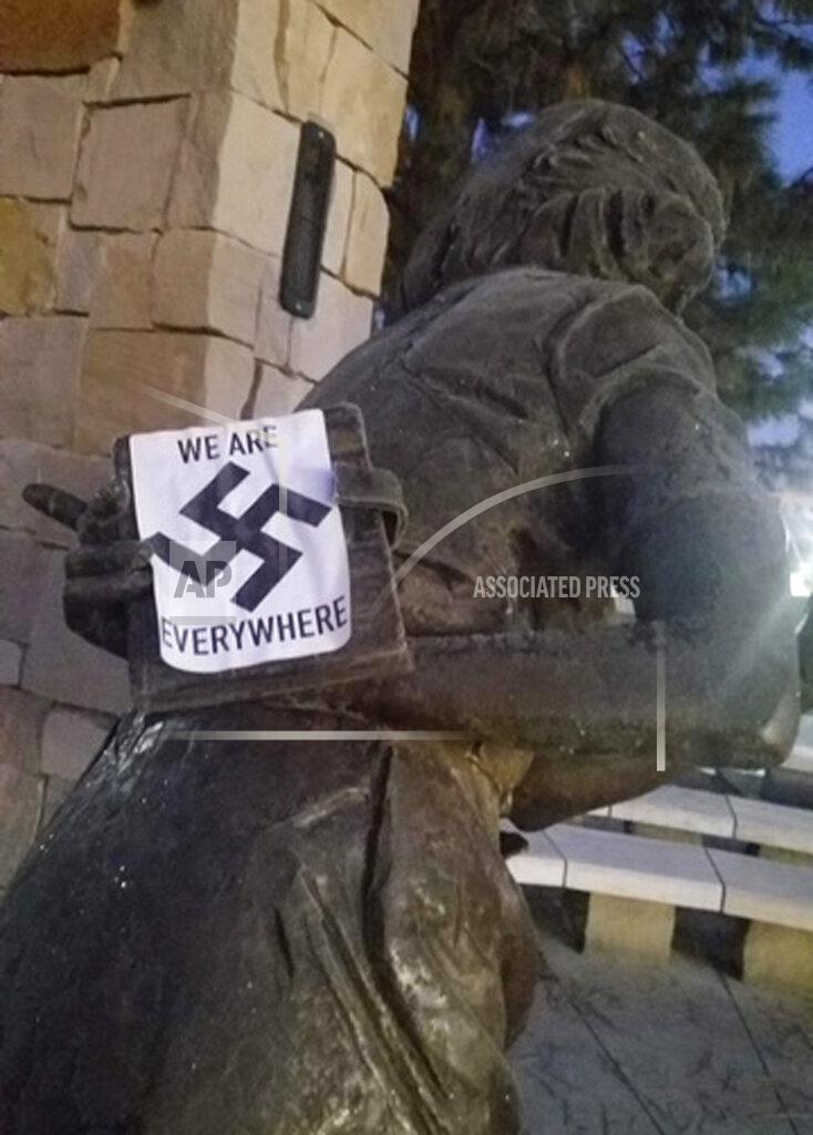 Uncredited In this photo provided by the Wassmuth Center for Human Rights, a swastika sticker is seen on a sculpture at the Idaho Anne Frank Human Rights Memorial in Boise, Idaho on Tuesday, Dec. 8, 2020. Boise police are investigating after the memorial was defaced by swastika stickers earlier this week. The stickers, which included the words, "we are everywhere" as well as the Nazi insignia, were discovered Tuesday morning by a visitor to the memorial in downtown Boise. (Wassmuth Center for Human Rights via AP)