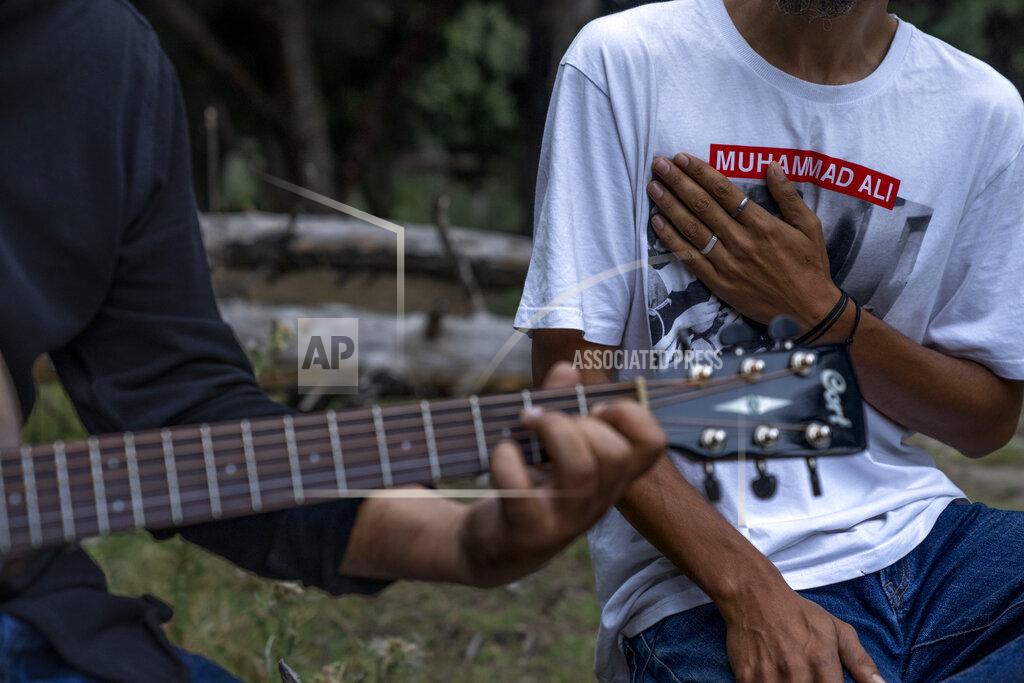 Dar Yasin Kashmiri musicians and singers Sarfaraz Javid, right, and Mohsin Hassan Bhat Jam on an island in the outskirts of Srinagar, Indian Kashmir, June 17, 2022. Musicians and artists in Kashmir are ordinary in life, each clutching onto the lived experiences of growing up in one of the world's most militarized zones that has known little but conflict for decades. But together, they embody a new form of music, a blend of progressive rock and hip hop that is an assertive expression of the region's political and cultural aspirations. (AP Photo/Dar Yasin)