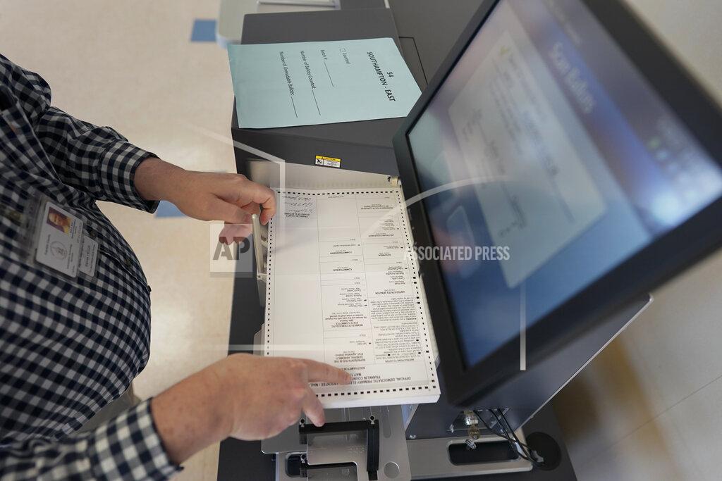 Carolyn Kaster Franklin County Director of Information Services Noll Witt loads mail-in and absentee ballots into a DS450 Ballot Scanner the morning after the Pennsylvania primary election at the Franklin County offices in Chambersburg, Pa., Wednesday, May 18, 2022. (AP Photo/ Carolyn Kaster)