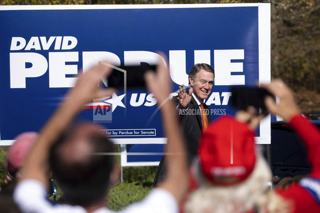Sen. David Perdue, R-Ga., takes the stage before Vice President Mike Pence during a Defend the Majority Rally, Friday, Nov. 20, 2020 in Canton, Ga. (AP Photo/Ben Gray)