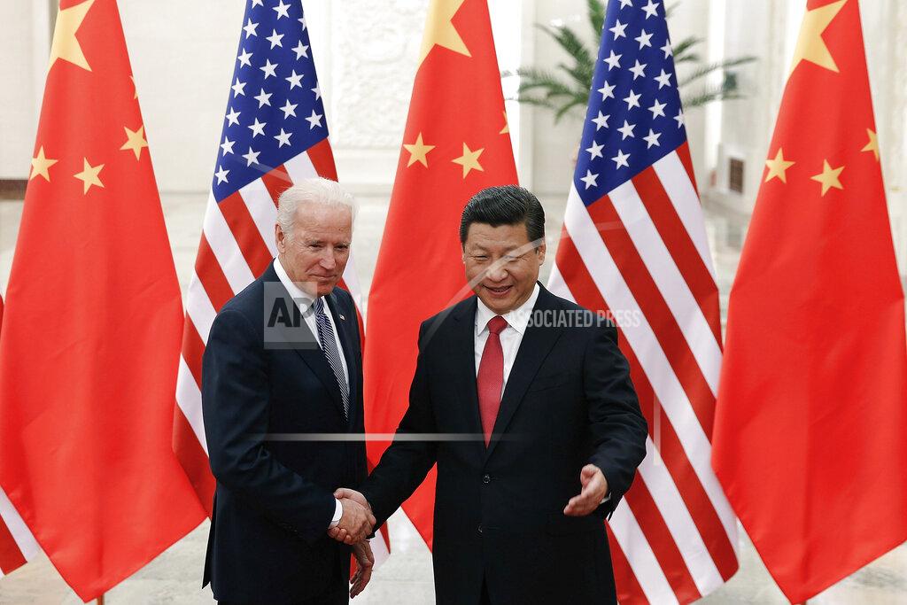 Lintao Zhang FILE - In this Dec. 4, 2013, file photo, Chinese President Xi Jinping, right, shakes hands with then U.S. Vice President Joe Biden as they pose for photos at the Great Hall of the People in Beijing. As Americans celebrate or fume over the new president-elect, many in Asia are waking up to the reality of a Joe Biden administration with decidedly mixed feelings. Relief and hopes of economic and environmental revival jostle with needling anxiety and fears of inattention. The two nations are inexorably entwined, economically and politically, even as the U.S. military presence in the Pacific chafes against China’s expanded effort to have its way in what it sees as its natural sphere of influence. (AP Photo/Lintao Zhang, Pool, File)