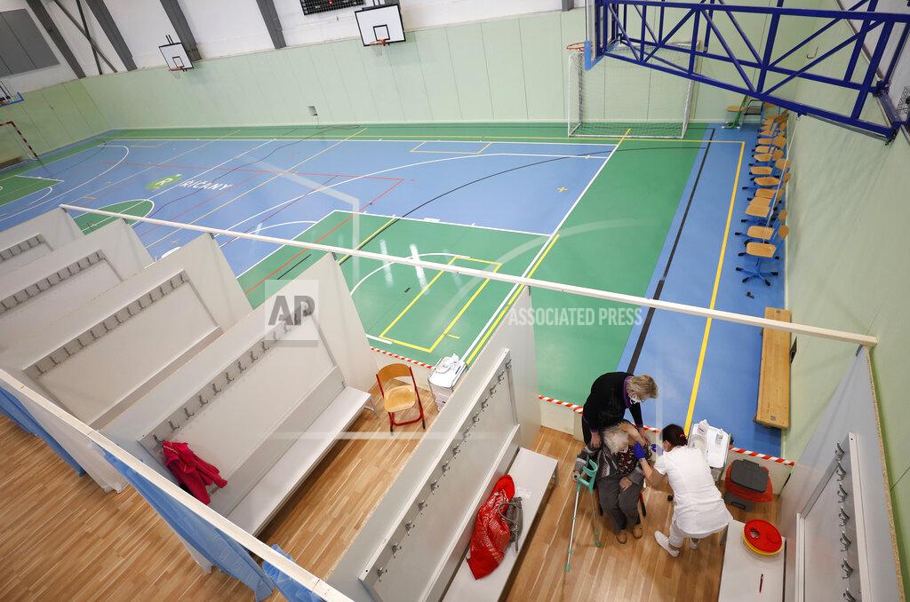 Petr David Josek An elderly woman receives Moderna COVID-19 vaccine at a sports hall in Ricany, Czech Republic, Friday, Feb. 26, 2021. With new infections soaring due to a highly contagious coronavirus variant and hospitals filling up, one of the hardest-hit countries in the European Union is facing inevitable: a tighter lockdown. (AP Photo/Petr David Josek)