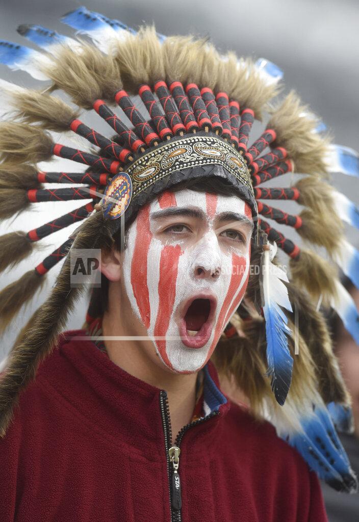 Mark Reis FILE - In this May 20, 2015, file photo, a Cheyenne Mountain High School student wears a headdress and face paint as he cheers for his school -- which uses "Indians" as its team mascot -- in the 4A State Soccer Championship game at Dick's Sporting Goods Park in Commerce City, Colo. The U.S. has spent most of 2019 coming to grips with blackface and racist imagery, including a racist photo on the Virginia governor’s college yearbook page. But Native Americans say they don't see significant pressure applied to those who perpetuate Native American stereotypes. (Mark Reis/The Gazette via AP, File)