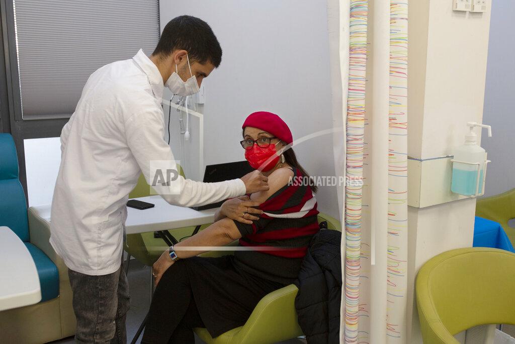 Maya Alleruzzo A nurse swabs a woman's arm before administering the coronavirus vaccine at a health center in Jerusalem, Wednesday, Dec. 30, 2020. (AP Photo/Maya Alleruzzo)