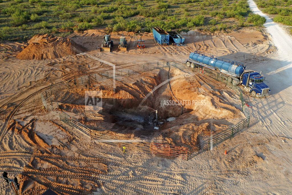Uncredited In this June 2021 photo provided by rancher Ashley Williams Watt, the Estes 24 well leaks on the Antina ranch near Crane, Texas. Chevron, which is responsible for the abandoned well, has been working to re-plug it. Buried under the sand, it became unplugged and started leaking produced water, a byproduct of oil production that is considered a toxic substance. The rancher's biggest worry is that it will get into her drinking water supply and the watershed, which flows into the nearby Pecos River. (Ashley Williams Watt via AP)