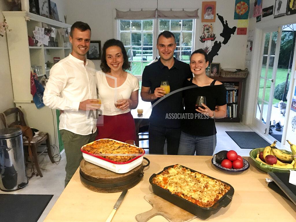 This April 3, 2020, photo provided by Felix Gard, shows German tourists from left, Felix Gard, Julia Betz, Thomas Metzler, Laura Spottke in Cambridge, New Zealand. Four German students who were invited by a New Zealand family to shelter with them during a nationwide lockdown say they've been having lots of fun sharing meals, playing football and trying to learn guitar. The students are among the 12,000 German visitors who have signed up for a repatriation program on flights chartered by the German government. (Felix Gard via AP)