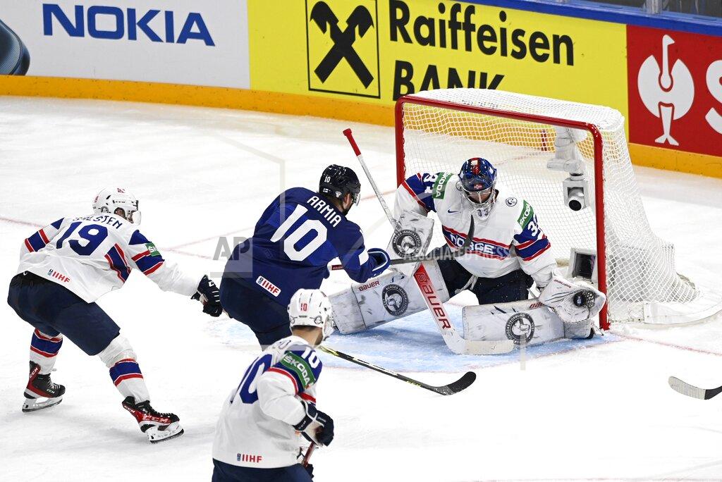 Emmi Korhonen Norway's goalie Henrik Haukeland makes a save from Finland's Joel Armia, center, during their preliminary round group B Hockey World Championship match between Finland and Norway in Tampere, Finland, Friday May 13, 2022. (Emmi Korhonen/Lehtikuva via AP)