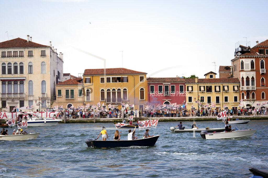 Antonio Calanni "No Big Ships" activists stage a protest as the MSC Orchestra cruise ship leaves Venice, Italy, Saturday, June 5, 2021. The 92,409-ton, 16-deck MSC Orchestra cruise ship, the first cruise ship leaving Venice since the pandemic is set to depart Saturday amid protests by activists demanding that the enormous ships be permanently rerouted out the fragile lagoon, especially Giudecca Canal through the city's historic center, due to environmental and safety risks. The ship passed two groups of protesters: pro-cruise advocates whose jobs depend on the industry as well as protesters who have been campaigning for years to get cruise ships out of the lagoon. (AP Photo/Antonio Calanni)