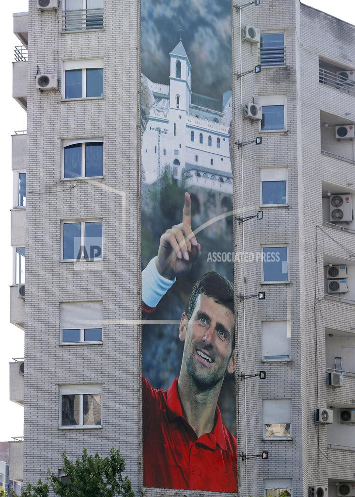 Darko Vojinovic A billboard depicting Serbian tennis player Novak Djokovic and the Christian Orthodox monastery of Ostrog is seen on a building in Belgrade, Serbia, Wednesday, June 24, 2020. Djokovic has tested positive for the coronavirus after taking part in a tennis exhibition series he organized in Serbia and Croatia. The top-ranked Serb is the fourth player to test positive for the virus after first playing in Belgrade and then again last weekend in Zadar, Croatia.(AP Photo/Darko Vojinovic)