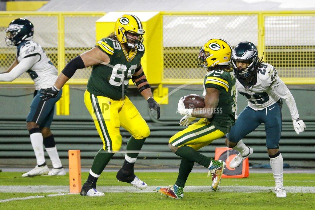 Mike Roemer Green Bay Packers' Aaron Jones runs for a 77-yard touchdown during the second half of an NFL football game against the Philadelphia Eagles Sunday, Dec. 6, 2020, in Green Bay, Wis. (AP Photo/Mike Roemer)