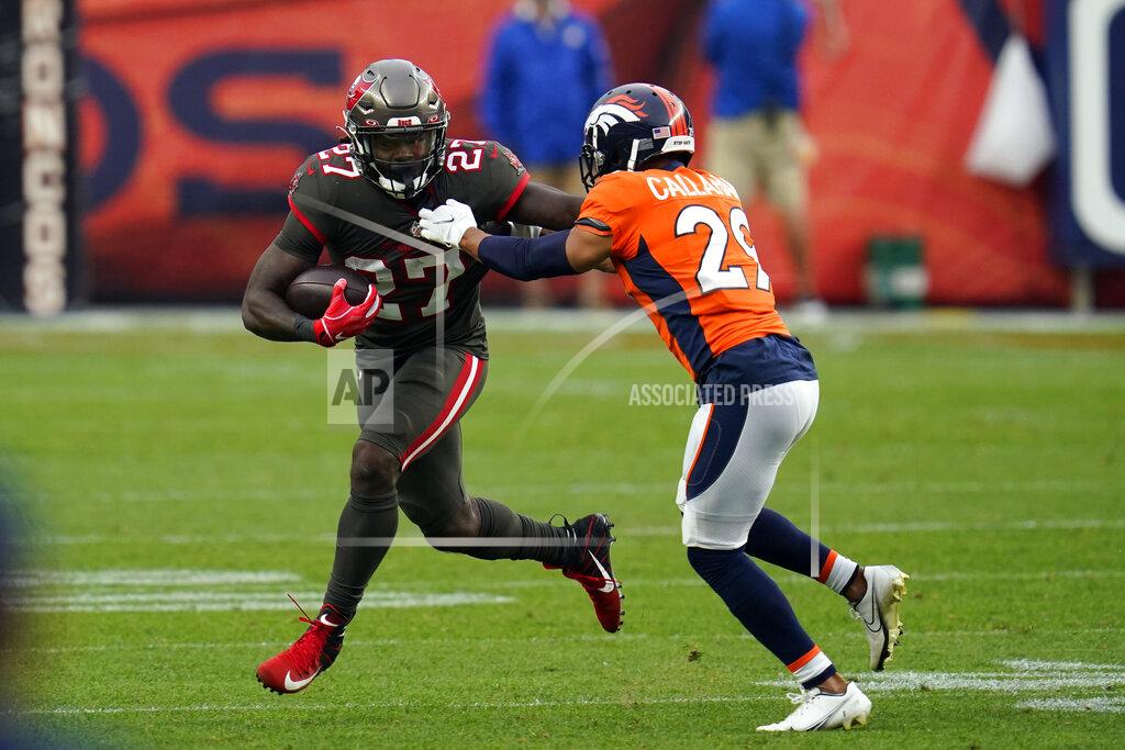 David Zalubowski Tampa Bay Buccaneers running back Ronald Jones runs with the ball as Denver Broncos cornerback Bryce Callahan defends during the second half of an NFL football game Sunday, Sept. 27, 2020, in Denver. (AP Photo/David Zalubowski)