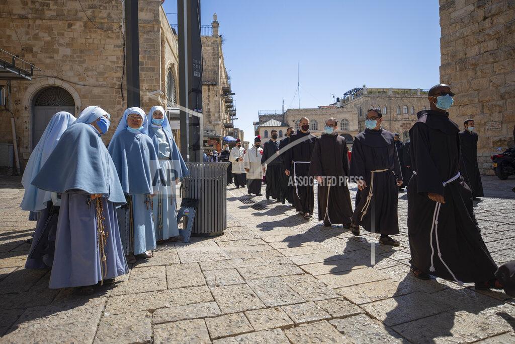 Oded Balilty Priests wearing face masks march after Easter Sunday mass, in the Old City of Jerusalem, Sunday, April. 4, 2021. (AP Photo/Oded Balilty)