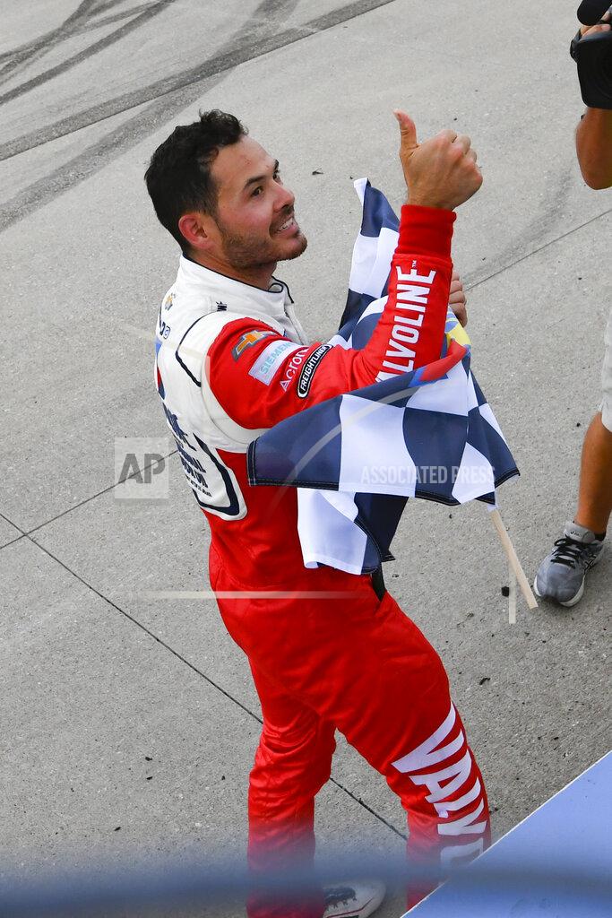 John Amis Kyle Larson gives a thumbs-up to fans after taking the checkered flag for winning a NASCAR Cup Series auto race Sunday, June 20, 2021, in Lebanon, Tenn. (AP Photo/John Amis)