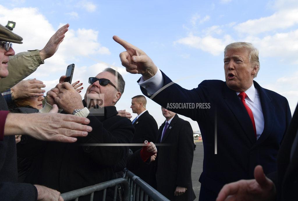 Susan Walsh President Donald Trump greets people after arriving via Air Force One at Philadelphia International Airport in Philadelphia, Saturday, Dec. 8, 2018. Trump is attending the Army-Navy football game. (AP Photo/Susan Walsh)