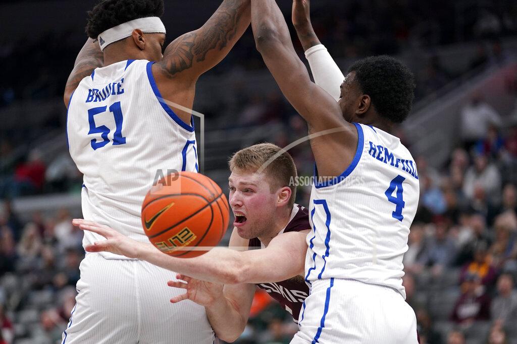 Jeff Roberson Southern Illinois' Marcus Domask, center, loses control of the ball between Drake's Darnell Brodie (51) and ShanQuan Hemphill (4) during the second half of an NCAA college basketball game in the quarterfinal round of the Missouri Valley Conference tournament Friday, March 4, 2022, in St. Louis. (AP Photo/Jeff Roberson)