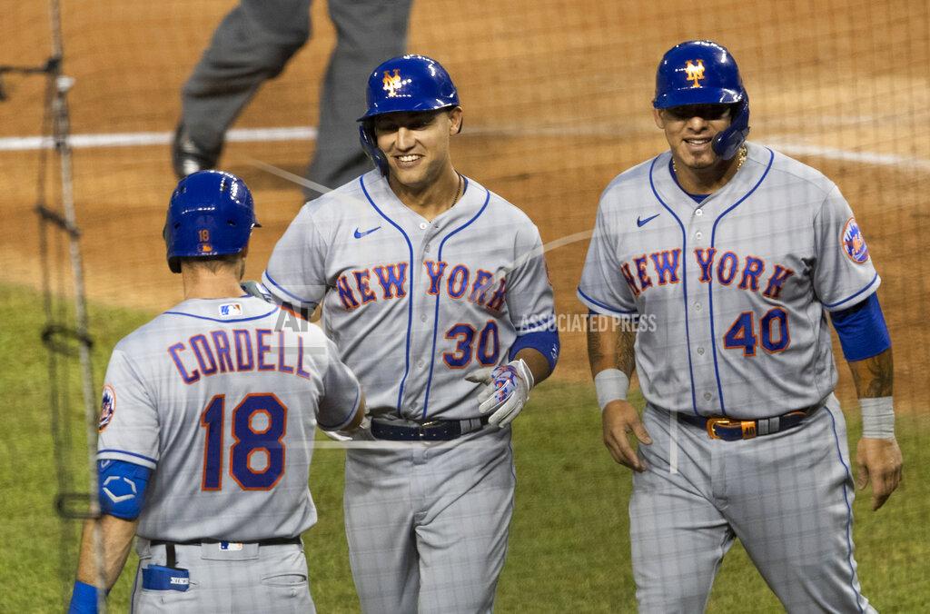 Manuel Balce Ceneta New York Mets Michael Conforto (30) is congratulated by his teammates Ryan Cordell (18) and Wilson Ramos (40) after hitting a home run during the fourth inning of a baseball game against the Washington Nationals in Washington, Tuesday, Aug. 4, 2020. Ramos also scored. (AP Photo/Manuel Balce Ceneta)