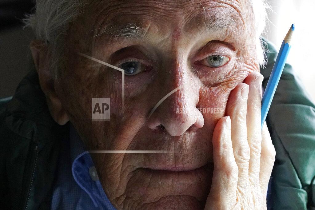 Charles Krupa Artist Robert Seaman poses in his room at an assisted living facility Monday, May 10, 2021, in Westmoreland, N.H. Seaman, who moved into the facility weeks before the COVID-19 pandemic shutdown his outside world in 2020, recently completed his 365th daily sketch, or what he calls his "Covid Doodles", since being isolated due to the virus outbreak. (AP Photo/Charles Krupa)