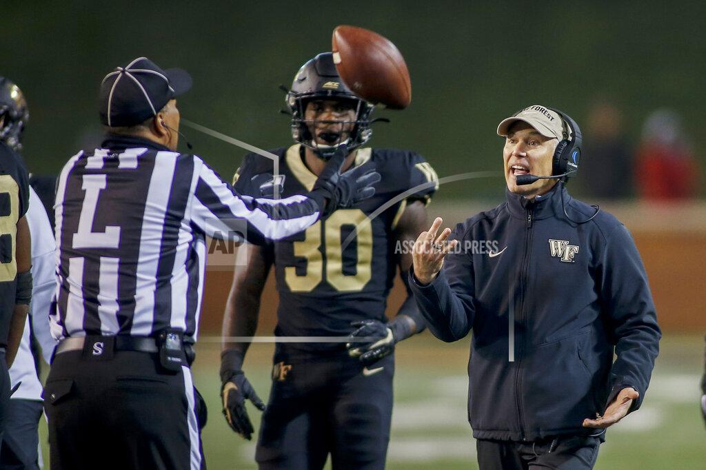 Nell Redmond Wake Forest head coach Dave Clawson, right, argues with line judge Tim Graham as Wake Forest linebacker Ja'Cquez Williams (30) looks on in the second half of an NCAA college football game against Duke in Winston-Salem, N.C., Saturday, Nov. 23, 2019. Wake Forest won 39-27. (AP Photo/Nell Redmond)