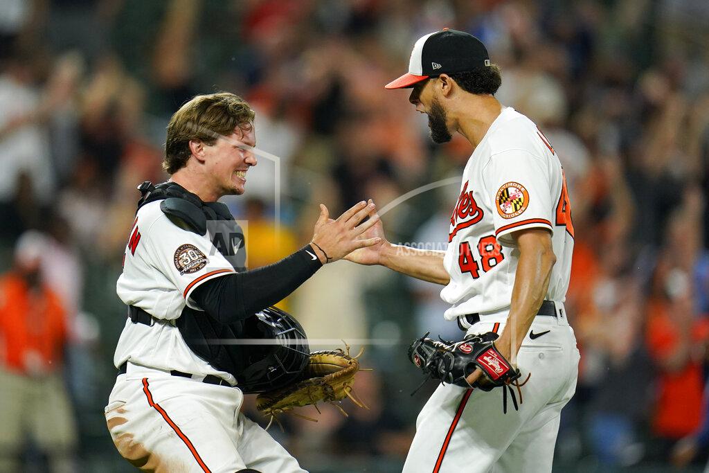 Julio Cortez Baltimore Orioles catcher Adley Rutschman, left, and relief pitcher Jorge Lopez react after a baseball game against the Tampa Bay Rays, Tuesday, July 26, 2022, in Baltimore. The Orioles won 5-3. (AP Photo/Julio Cortez)