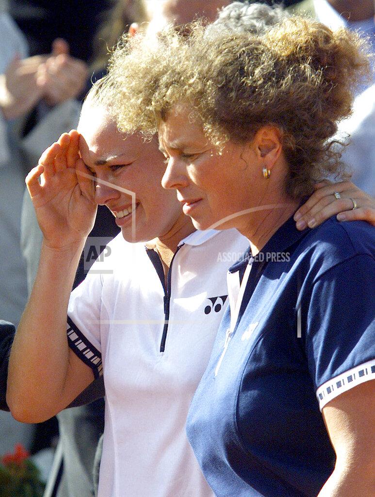 Michel Euler FILE - In this June 5, 1999, file photo, top-seeded Martina Hingis arrives in tears with her mother Melanie Monitor for the trophy ceremony after she lost to sixth-seeded Steffi Graf 4-6, 7-5, 6-2 in the women's final tennis match at the French Open at Roland Garros stadium in Paris. Sporting events can be memorable for all sorts of reasons, and sometimes more than one, from upsets to historical significance to moments of drama to big comebacks and more. (AP Photo/Michel Euler, File)