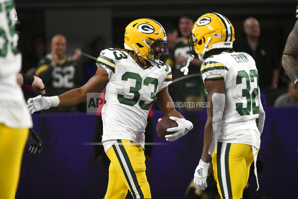 Craig Lassig Green Bay Packers running back Aaron Jones (33) celebrates with Tyler Ervin after scoring on a 56-yard run during the second half of the team's NFL football game against the Minnesota Vikings, Monday, Dec. 23, 2019, in Minneapolis. (AP Photo/Craig Lassig)