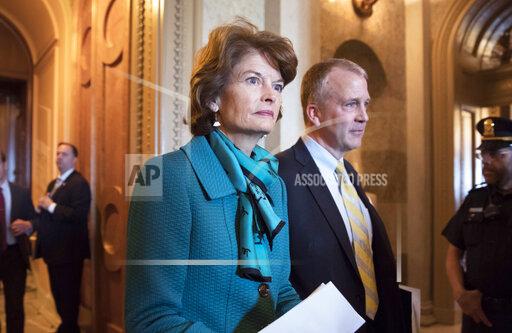 FILE - Sen. Lisa Murkowski, R-Alaska, and Sen. Dan Sullivan, R-Ark., leave the chamber after a vote on Capitol Hill in Washington, early Wednesday, May 10, 2017. A magistrate ruled Tuesday, Oct. 19, 2021, that there is probable cause for a case to continue against a man accused of threatening to kill Alaska’s two U.S. senators in profanity-filled voicemails left on their office phones. (AP Photo/J. Scott Applewhite, File)