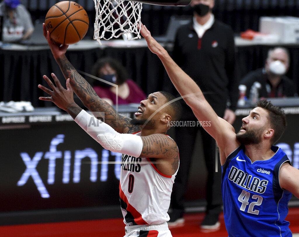 Steve Dykes Portland Trail Blazers guard Damian Lillard, left, drives to the basket past Dallas Mavericks forward Maxi Kleber during the first half of an NBA basketball game in Portland, Ore., Friday, March 19, 2021. AP Photo/Steve Dykes)