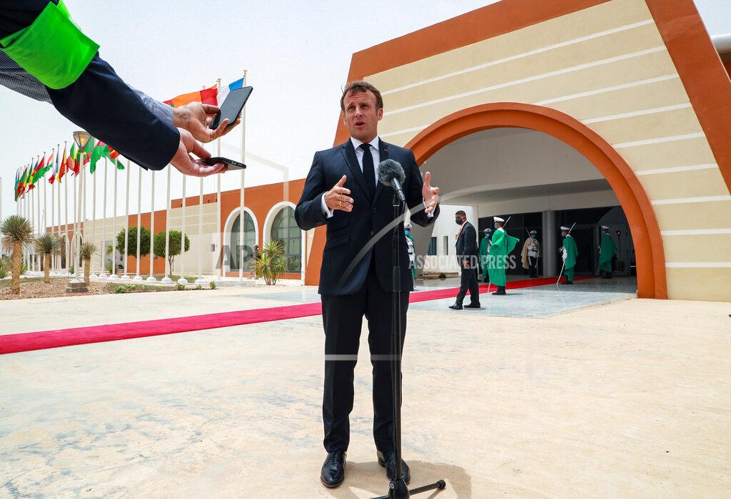 Ludovic Marin French President Emmanuel Macron speaks to the press upon arrival at Nouakchott Oumtounsy International Airport Tuesday June 30, 2020, in Nouakchott, to attend a G5 Sahel summit. Leaders from the five countries of West Africa's Sahel region, Burkina Faso, Chad, Mali, Mauritania and Niger, meet with French President Emmanuel Macron and Spanish Prime Minister Pedro Sanchez in Mauritania's capital Nouakchott on Tuesday to discuss military operations against Islamic extremists in the region, as jihadist attacks mount. The five African countries, known as the G5, have formed a joint military force that is working with France, which has thousands of troops to battle the extremists in the Sahel, the region south of the Sahara Desert. (Ludovic Marin, Pool via AP)